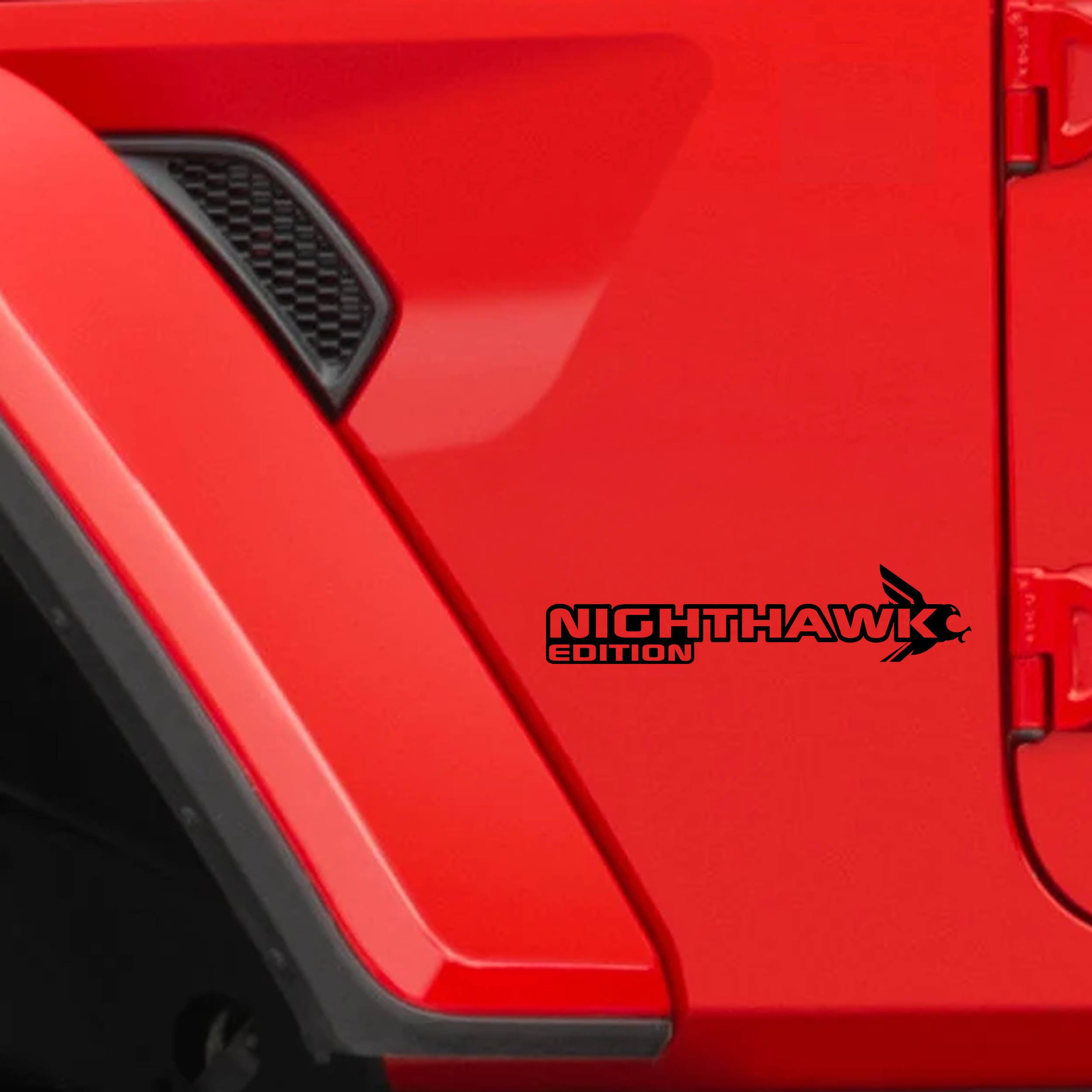 Nighthawk Edition fender decal in black on a red Jeep front fender behind the vent