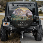 Rocky Mountain National Park spare tire cover on a Jeep Wrangler, showing a bull elk below snow-capped peaks
