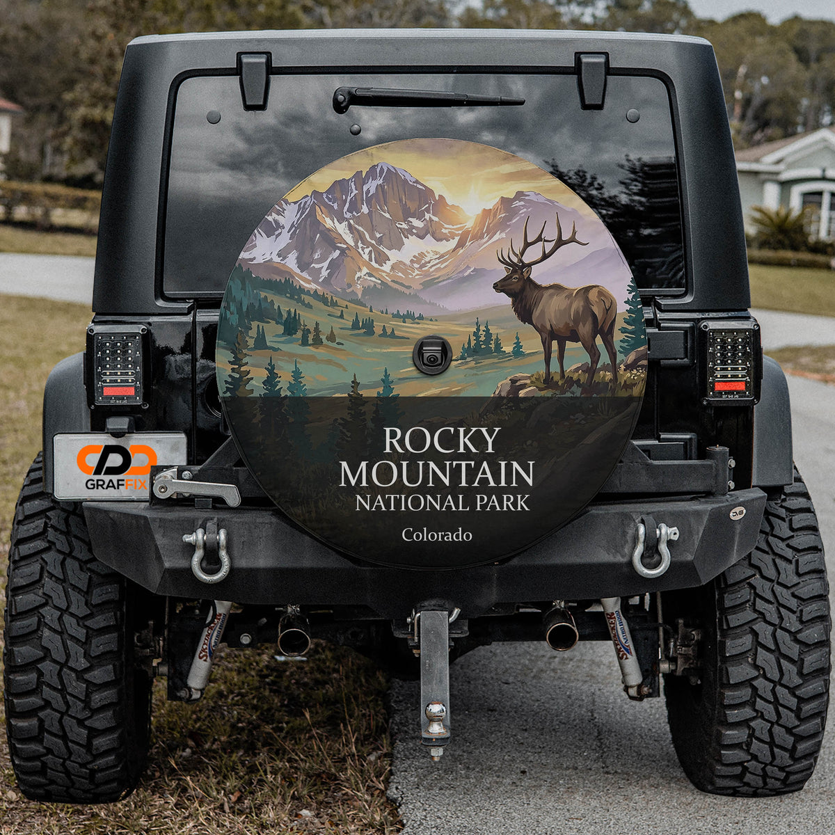 Rocky Mountain National Park spare tire cover on a Jeep Wrangler, showing a bull elk below snow-capped peaks