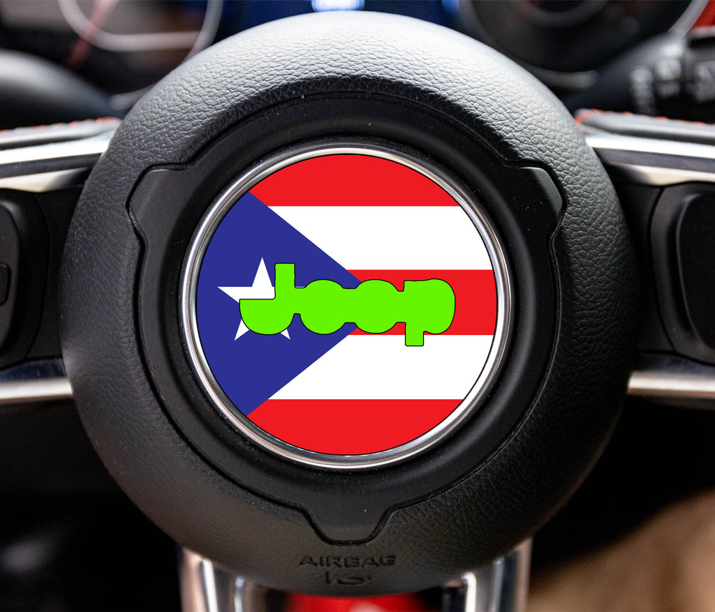 Round Puerto Rico flag decal with white-star blue triangle, red stripes, and green Jeep logo on wheel hub