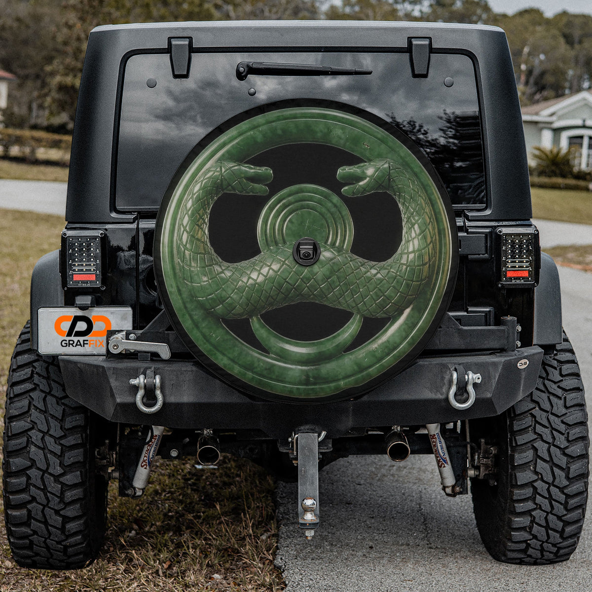 Jade serpent cult amulet spare tire cover mounted on a Jeep Wrangler