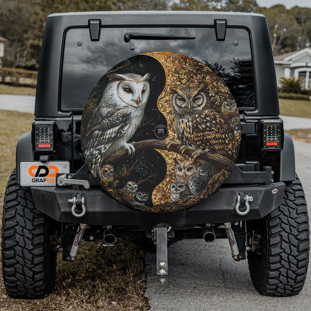 Yin-Yang Owls spare tire cover mounted on a Jeep Wrangler rear wheel with the mystical paired owls in soft light