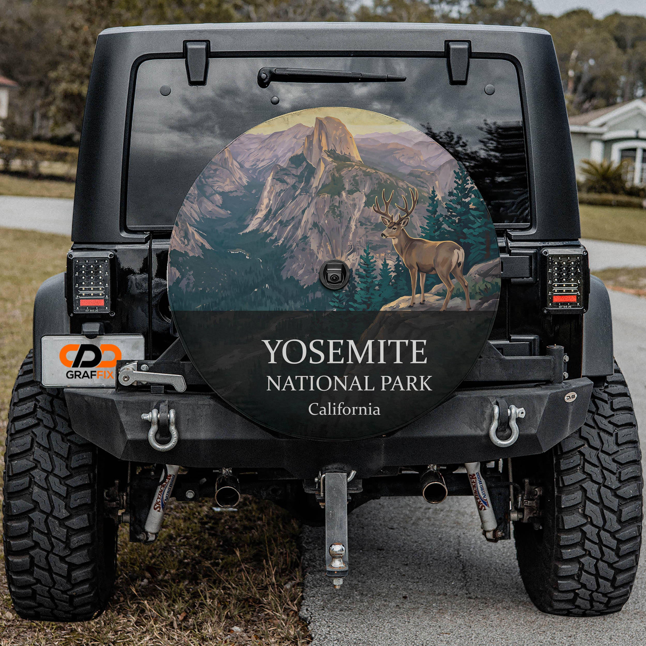 Yosemite National Park spare tire cover on a Jeep Wrangler, showing a mule deer on an outcrop below Half Dome