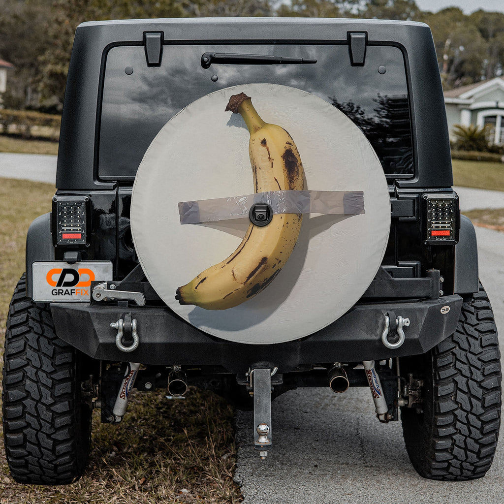 Duct-Taped Banana spare tire cover with banana taped to wall shown on black Jeep CDD GRAFFIX