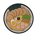 A plate of food with various ingredients, including sliced meat, noodles, and vegetables, arranged in a circular pattern.