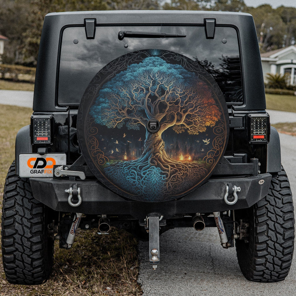 Round Norse Tree of Life tire cover on white showing teal autumn branches Celtic knot roots design