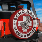 a red Jeep with a tire cover that says "Echo Base Search & Rescue" and has a graphic of a llama carrying a first aid kit.