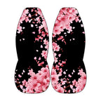two identical flower-patterned objects, one on each side, with pink flowers and petals against a black background.