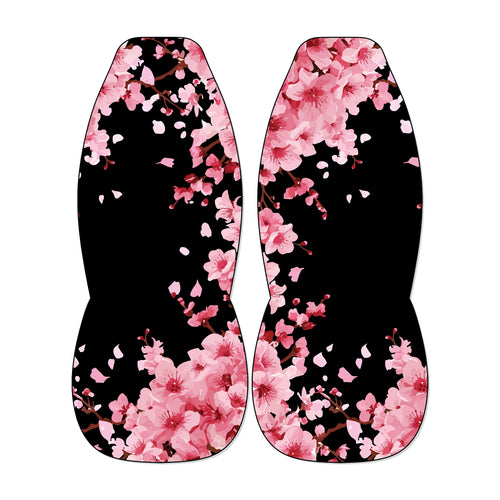 two identical flower-patterned objects, one on each side, with pink flowers and petals against a black background.
