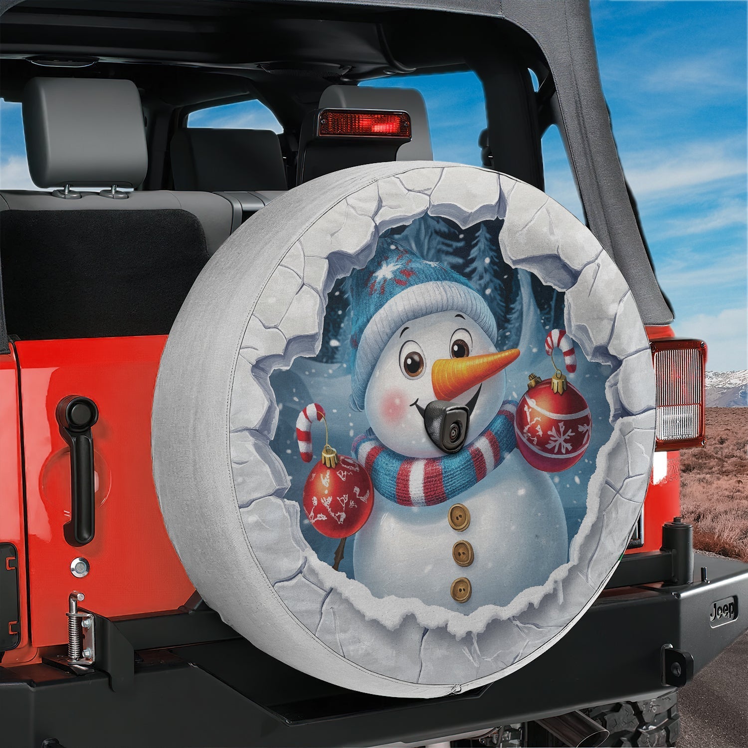 Frosty snowman ice breaker spare tire cover mounted on the rear of a black Jeep Wrangler