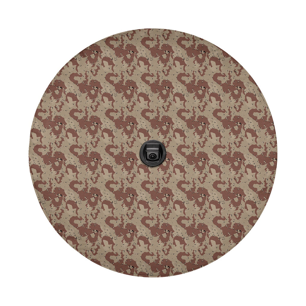 Chocolate chip desert pattern tire cover mounted on black Jeep Wrangler rear in suburban neighborhood