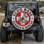 the back of a black Jeep with a large, circular decal on the rear window that says "ECHO BASE SEARCH & RESCUE".