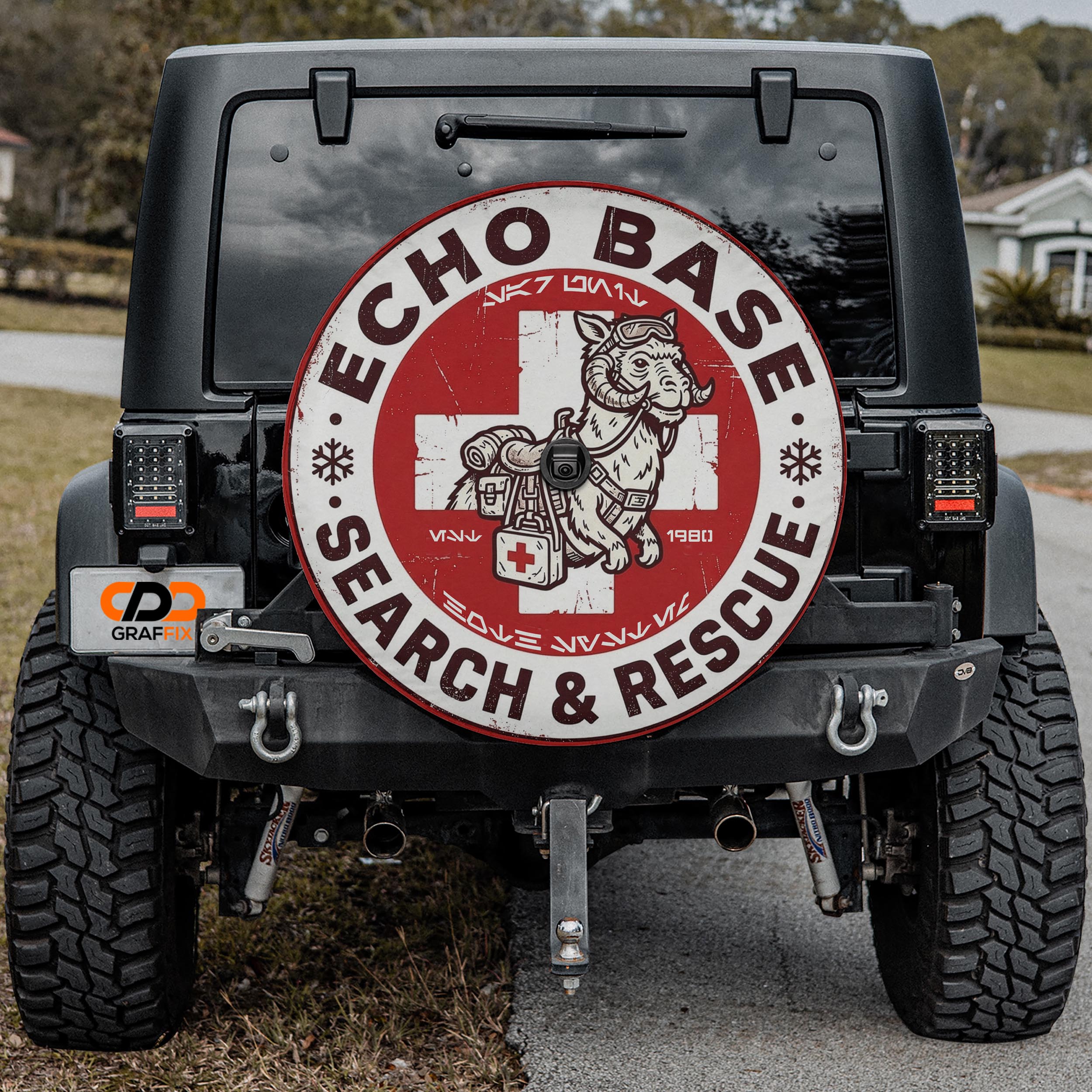 the back of a black Jeep with a large, circular decal on the rear window that says "ECHO BASE SEARCH & RESCUE".