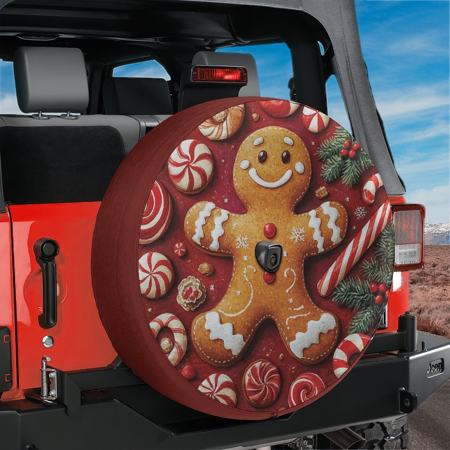 Gingerbread man cookie tire cover artwork with peppermint candies pine sprigs and snowflakes on red