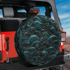Golden teal waves tire cover on a red Jeep Wrangler with stylized water curls and backup camera hole