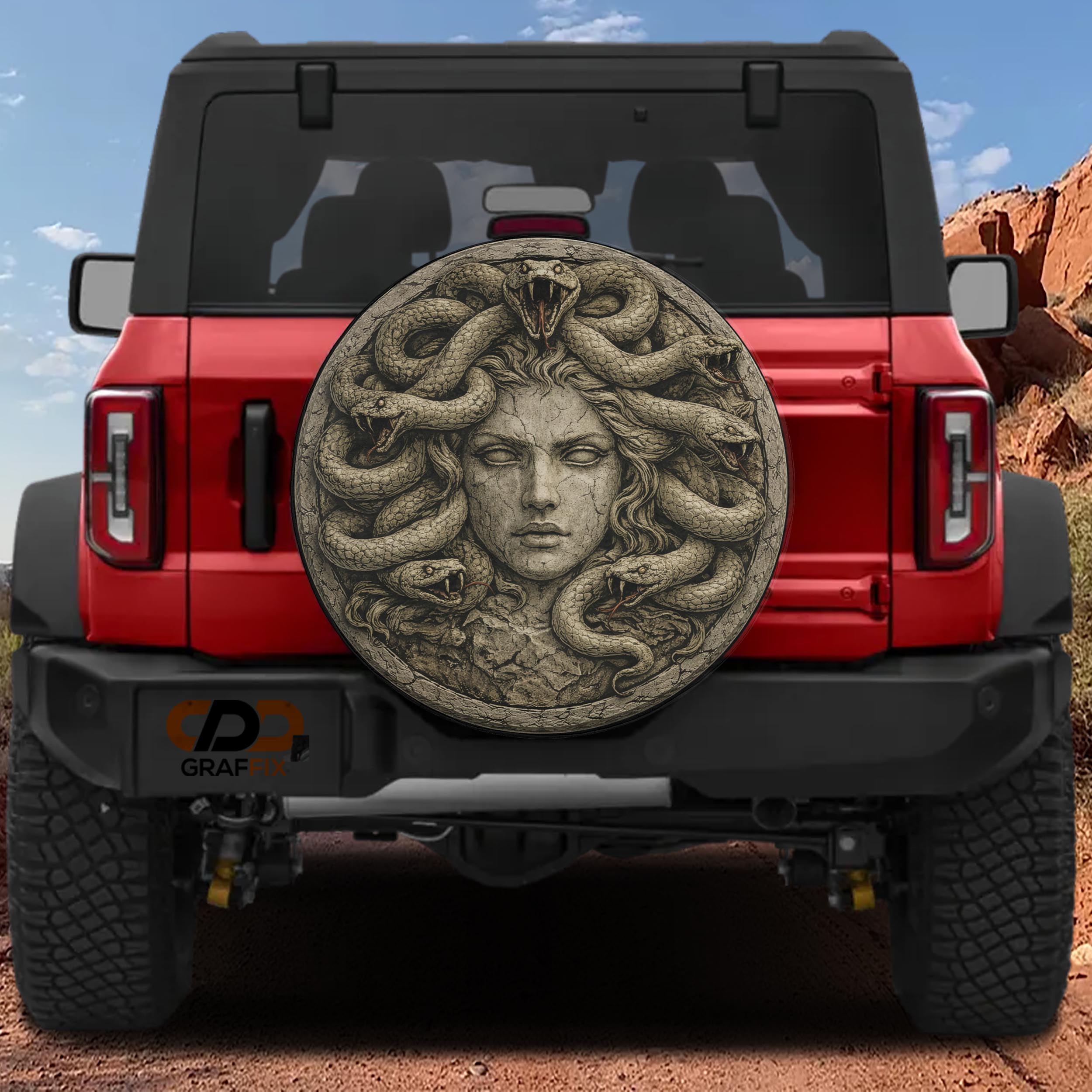 a red Jeep Wrangler with a large, detailed stone carving of a woman's face on the rear window.