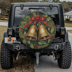 Festive wreath and golden bells spare tire cover mounted on a Jeep showing holiday holly accents