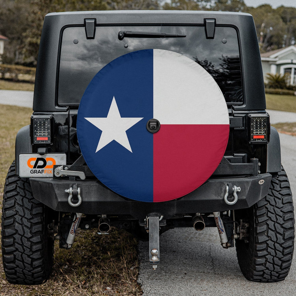Texas state flag spare tire cover on red Jeep Wrangler with desert backdrop featuring Lone Star design