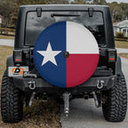 Texas state flag spare tire cover close-up on red Jeep Wrangler showing crisp Lone Star detail in desert setting