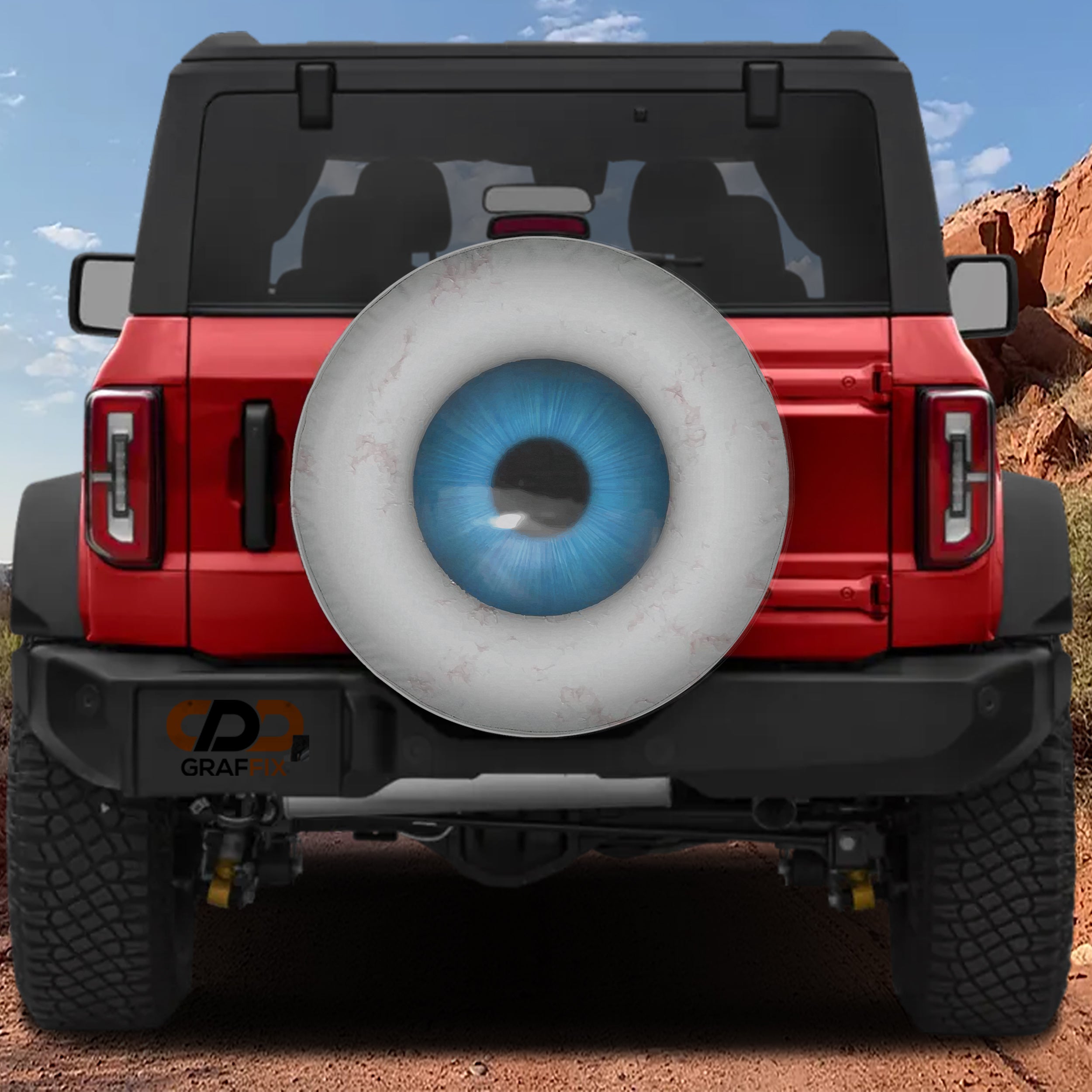 Eye On You spare tire cover on a red Jeep Wrangler showing a blue iris design on the rear-mounted spare wheel