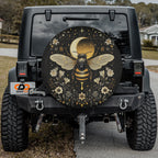 Celestial Buzz bee tire cover on a black Jeep rear with golden moon bee, stars and floral wreath art
