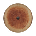 a close-up view of a wooden tree trunk or branch, with a black camera or lens visible in the center.