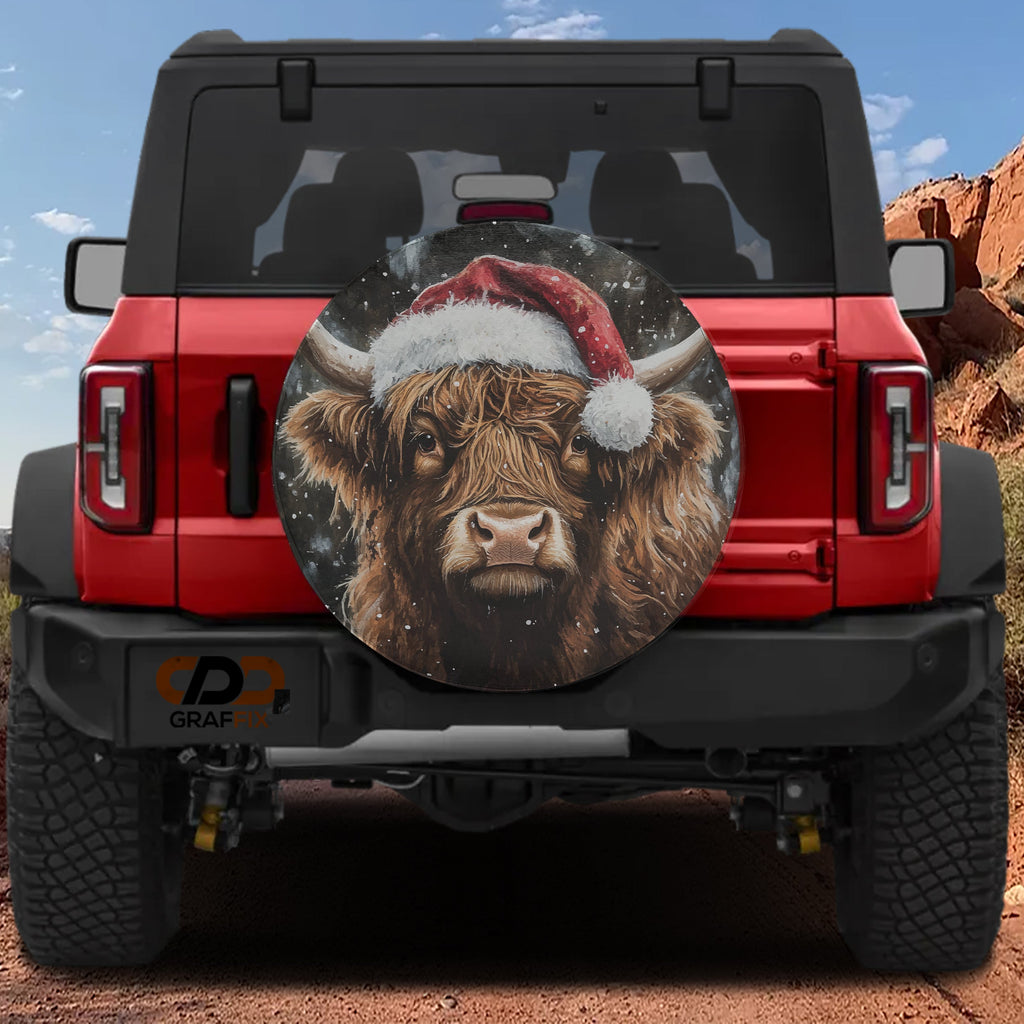 Highland Christmas Cow spare tire cover on a red Jeep Wrangler with shaggy cow in a Santa hat