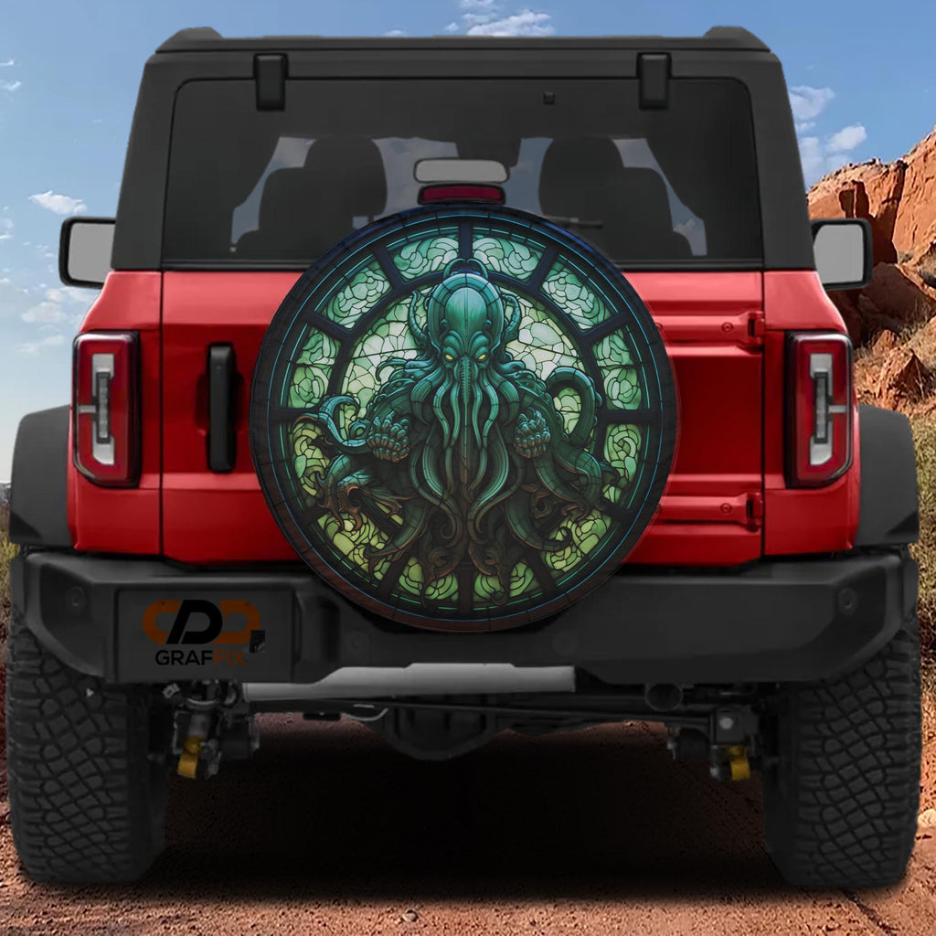 Cthulhu Rising stained glass tire cover flat artwork with green octopus deity in dark ornate cathedral window
