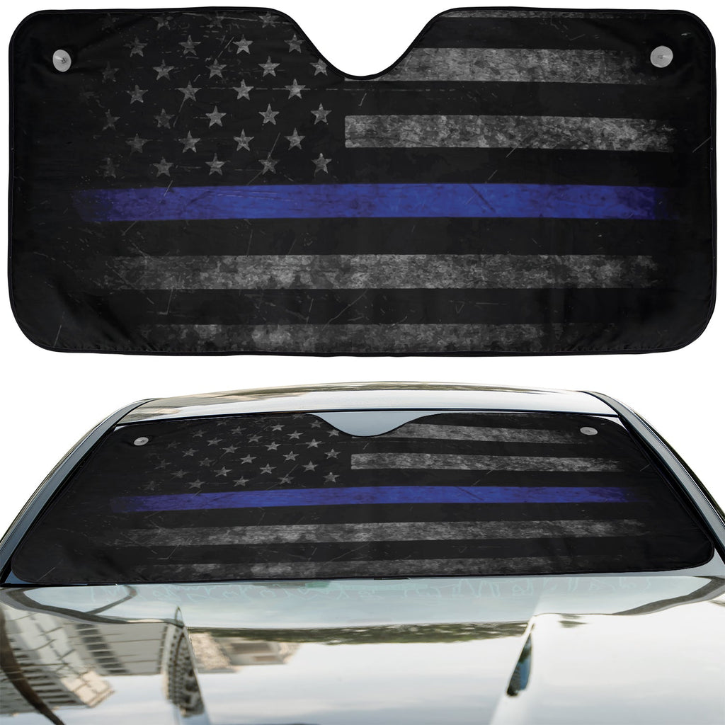 Thin Blue Line American Flag accordion sunshade installed in a sedan windshield on a sunny city street view