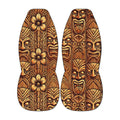 two tiki boards with intricate, colorful designs and patterns, including various facial expressions and floral elements.