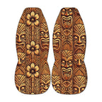 two tiki boards with intricate, colorful designs and patterns, including various facial expressions and floral elements.