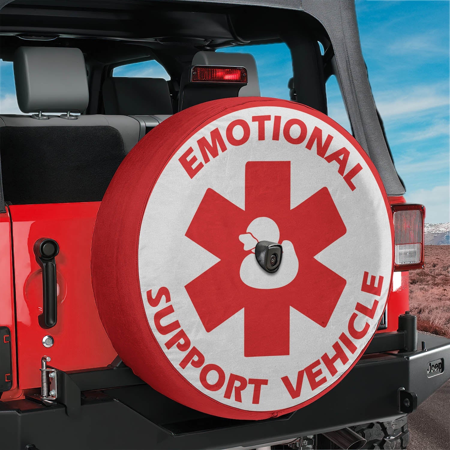 Emotional Support Vehicle rubber duck red star tire cover on red Jeep Wrangler with desert horizon