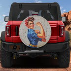 War Effort Woman Power-Up spare tire cover on a red Jeep Wrangler featuring riveted Rosie art