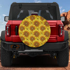 Sunflower field spare tire cover on red Ford Bronco showing dense yellow sunflower blooms with brown centers