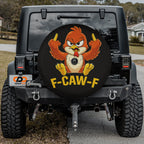 a black Jeep Wrangler with a large tire cover featuring a cartoon bird character.