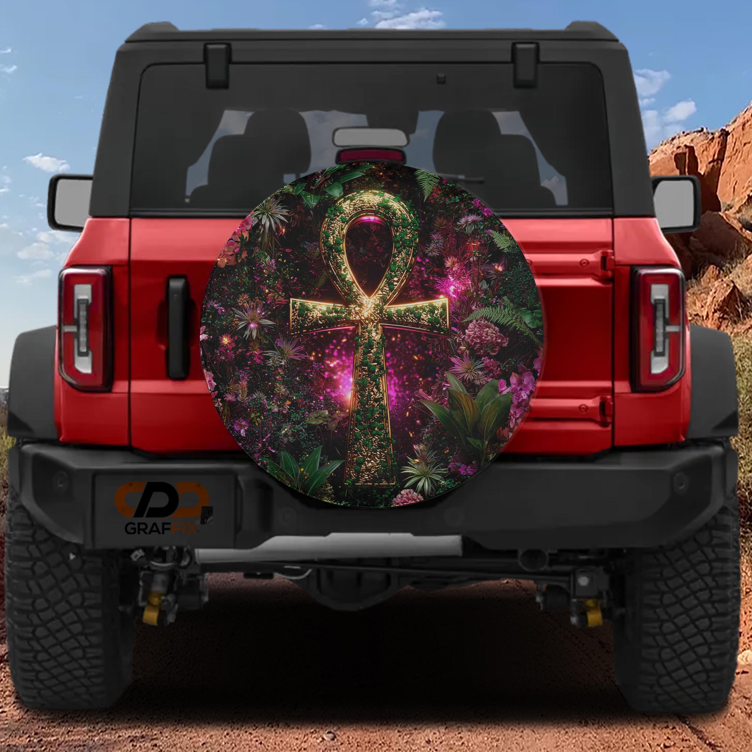 a red Jeep Wrangler with a large, colorful wheel cover on the back.