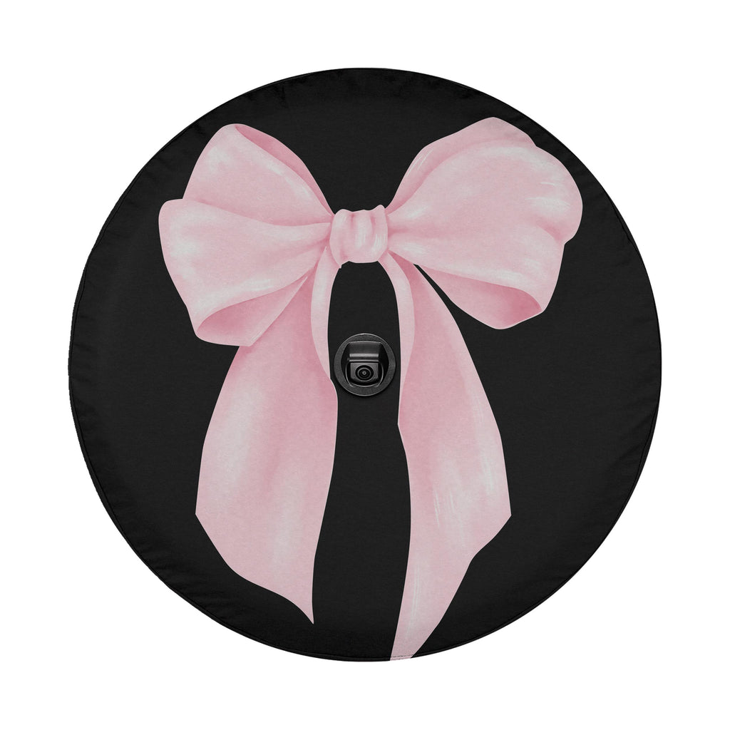 A black wheel cover with a large pink bow on it.