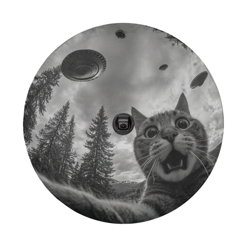 A black and white image of a cat with wide-open eyes and an expression of surprise, surrounded by trees and flying saucers in the sky.