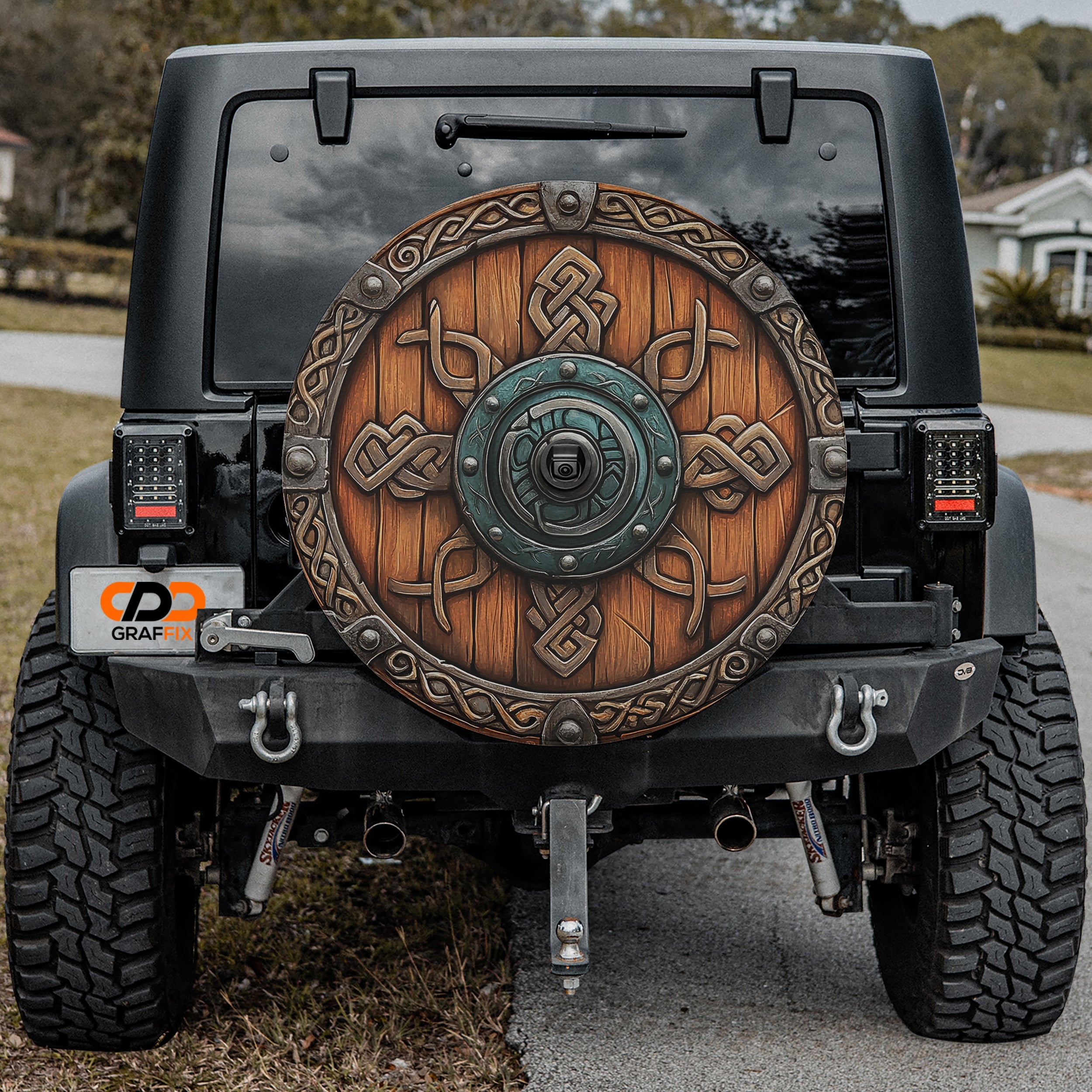 Viking Celtic shield spare tire cover installed on rear of Jeep vehicle