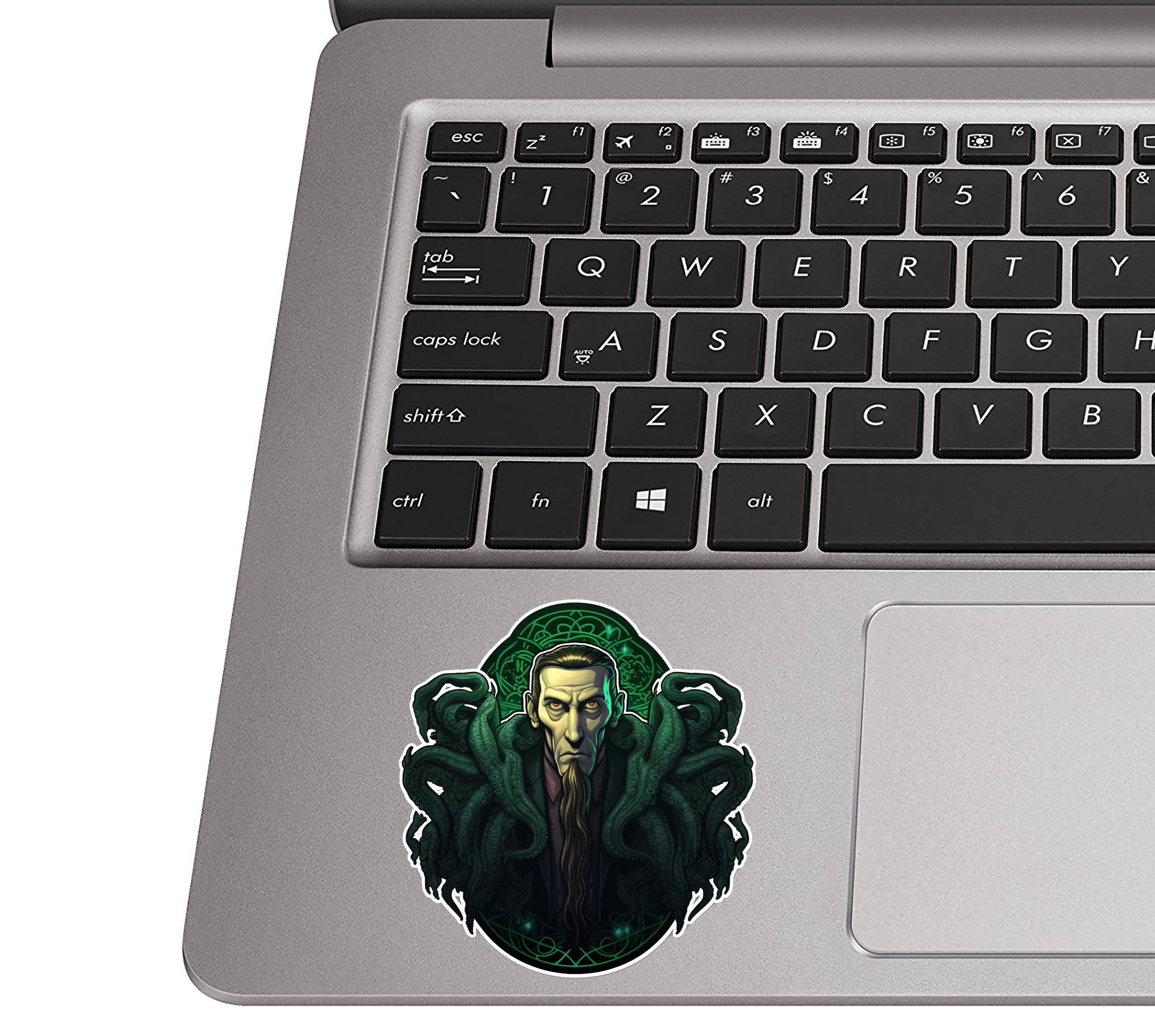 Cthulhu Celtic Knot sticker on silver laptop palm rest near black QWERTY keys showing realistic install size