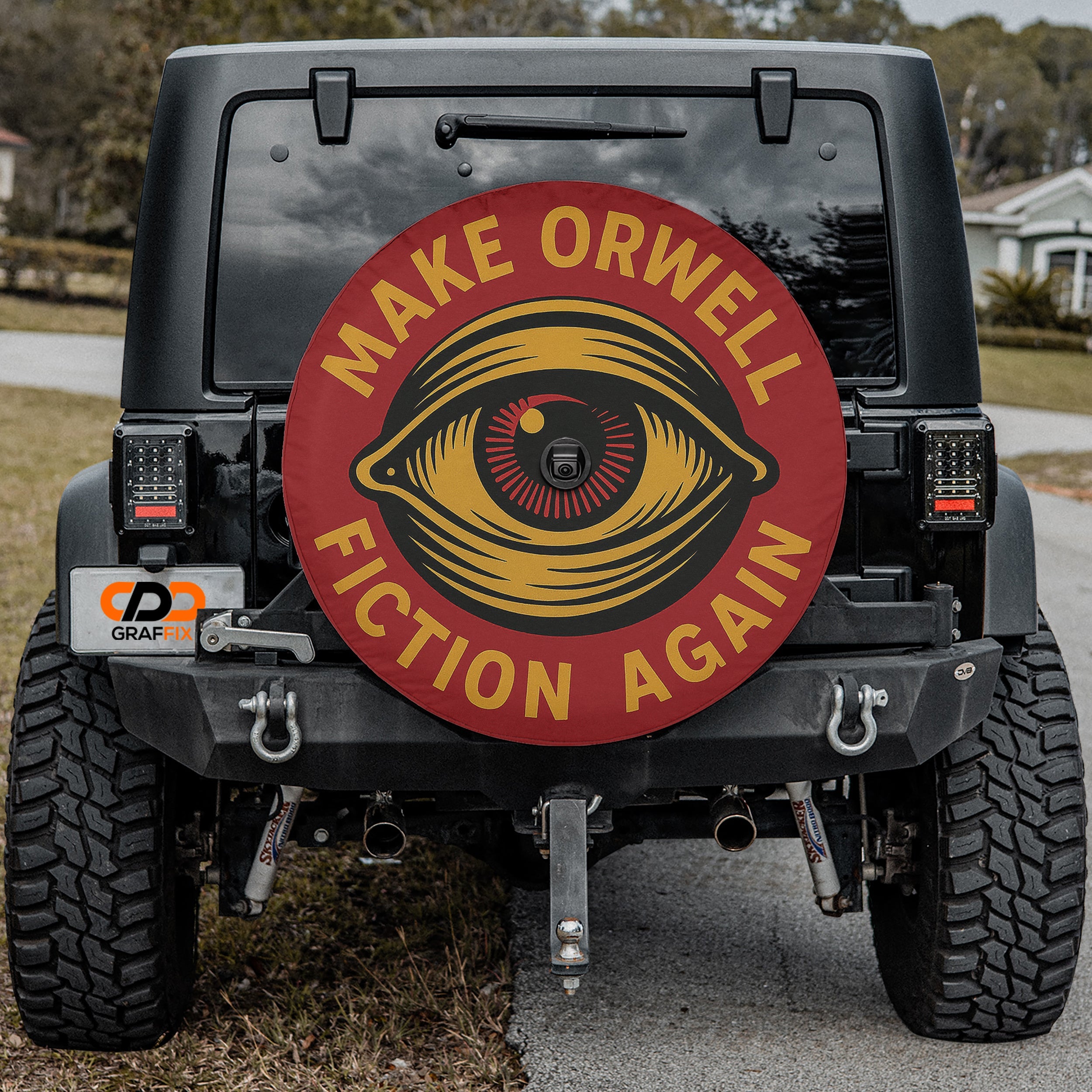 the back of a black jeep with a large red and yellow sticker on the rear window that says "Make Orwell Fiction Again".