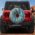 a red Jeep Wrangler with a large, colorful donut-shaped air freshener hanging from the rear window.