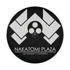 Flat Nakatomi Plaza Los Angeles spare tire cover artwork with white chevron logo on a black circular canvas