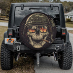 Close-up burning reflections army skull spare tire cover disc with cigar, helmet, flame shades and camera hole