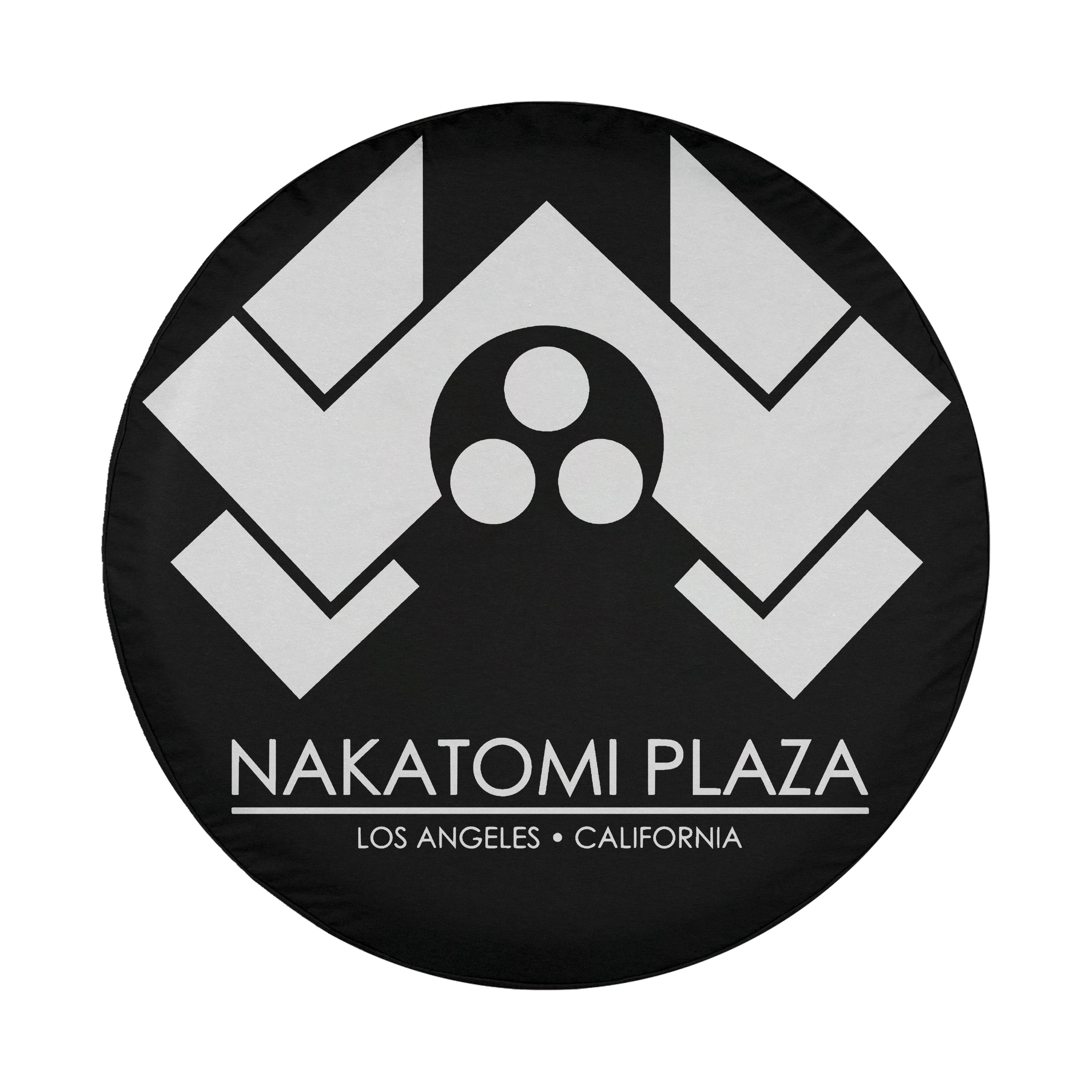 Round Nakatomi Plaza spare tire cover with white chevron logo and Los Angeles California text on black