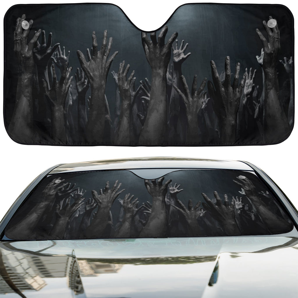 Rise Up Zombie Hands accordion sunshade installed in a sedan windshield on a sunny city street view