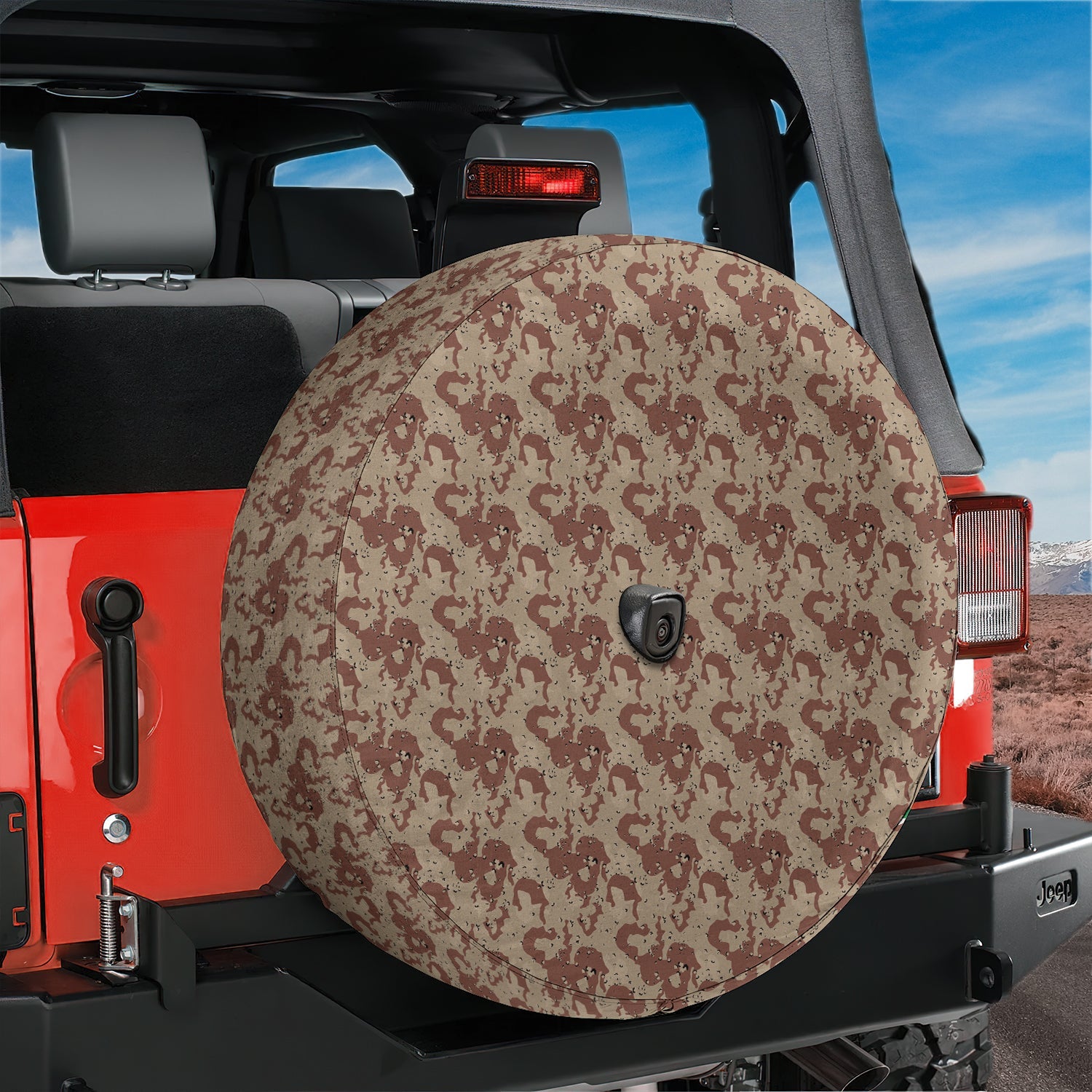 Sand Desert Storm camo tire cover with backup camera hole mounted on red Jeep Wrangler rear gate