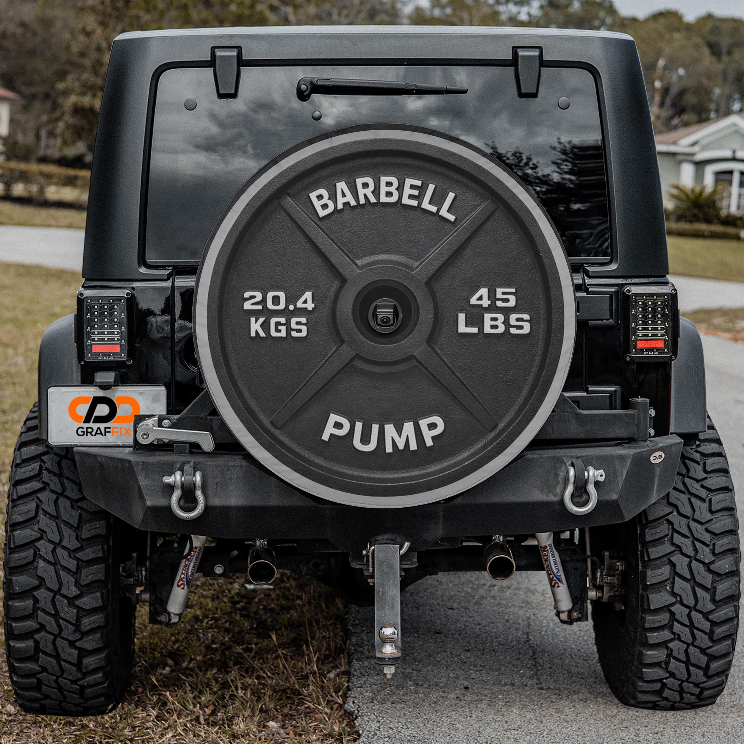 a black Jeep Wrangler with a large barbell attached to the rear of the vehicle.