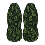 two identical car seat covers with a repeating pattern of green leaves and branches.