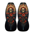 a pair of dark-colored shoes with a skull design and floral elements on the sides.